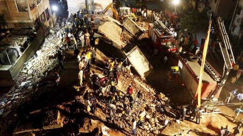 Teams of the National Disaster Response Force (NDRF) and the local fire brigade were deployed to rescue people from the debris of the two blocks, each four-storeyed, said Minister of State for Home Pradipsinh Jadeja. (Photo: PTI) Teams of the National Disaster Response Force (NDRF) and the local fire brigade were deployed to rescue people from the debris of the two blocks, each four-storeyed, said Minister of State for Home Pradipsinh Jadeja. (Photo: PTI)