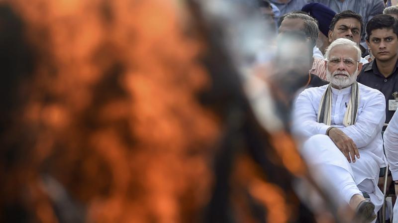 Prime Minister Narendra Modi during the cremation of former prime minister Atal Bihari Vajpayee with full state honour, at Rashtriya Smriti Sthal in New Delhi on Friday, Aug 17, 2018. (Photo: PTI) Prime Minister Narendra Modi during the cremation of former prime minister Atal Bihari Vajpayee with full state honour, at Rashtriya Smriti Sthal in New Delhi on Friday, Aug 17, 2018. (Photo: PTI)