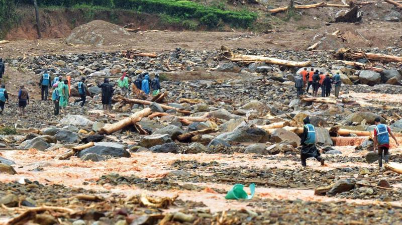 Rescue workers at Puthumala where a landslide on Thursday washed away a town Rescue workers at Puthumala where a landslide on Thursday washed away a town