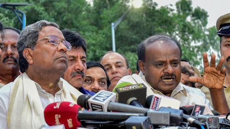 Outgoing Karnataka Chief Minister Siddaramaiah and JD(S) President HD Kumaraswamy address the media after a meeting with Governor Rudabhai Vala in relation with in Bengaluru on Tuesday. (Photo: PTI) Outgoing Karnataka Chief Minister Siddaramaiah and JD(S) President HD Kumaraswamy address the media after a meeting with Governor Rudabhai Vala in relation with in Bengaluru on Tuesday. (Photo: PTI)