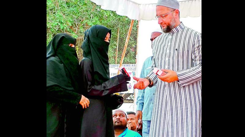 Hyderabad MP and AIMIM president Asaduddin Owaisi distributes pepper spray to female students for their safety during the launch of the Women & Child Safety Awareness Campaign on Tuesday. (Photo: Gandhi) Hyderabad MP and AIMIM president Asaduddin Owaisi distributes pepper spray to female students for their safety during the launch of the Women & Child Safety Awareness Campaign on Tuesday. (Photo: Gandhi)