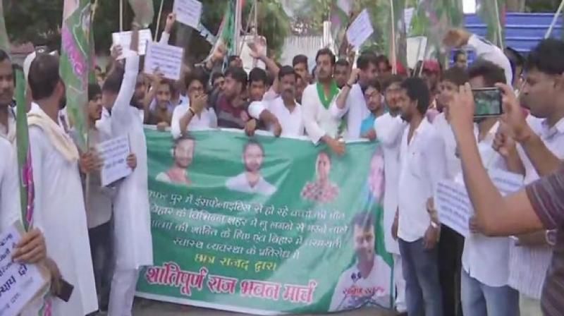 Holding posters and shouting slogans, they marched to Raj Bhavan in the state capital. (Photo: ANI) Holding posters and shouting slogans, they marched to Raj Bhavan in the state capital. (Photo: ANI)