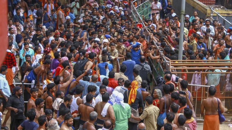 Protestors gather as a Trichy resident who had trekked up with her family to Sabarimala temple, in Pathanamthitta, on Saturday. (Photo: PTI) Protestors gather as a Trichy resident who had trekked up with her family to Sabarimala temple, in Pathanamthitta, on Saturday. (Photo: PTI)