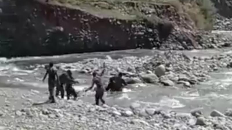 A screen grab of the video in which a CRPF jawan can be seen jumping in the stream and is followed by a colleague as the girl is washed away by the currents of Ferozpora stream near Srinagar on Monday. A screen grab of the video in which a CRPF jawan can be seen jumping in the stream and is followed by a colleague as the girl is washed away by the currents of Ferozpora stream near Srinagar on Monday.
