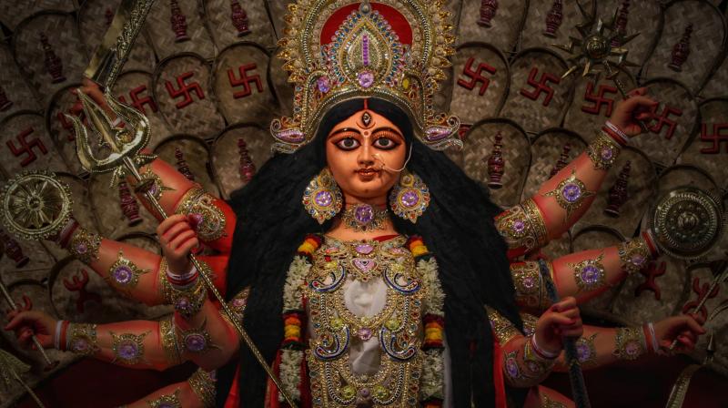A popular North Kolkata Durga Puja idol. The ten hands of Lord Durga hold in them a conch, discuss, lotus, sword, bow with arrow, trishul, mace, thunderbolt, snake and flame. (Photo: Debojyoti Sanyal) A popular North Kolkata Durga Puja idol. The ten hands of Lord Durga hold in them a conch, discuss, lotus, sword, bow with arrow, trishul, mace, thunderbolt, snake and flame. (Photo: Debojyoti Sanyal)