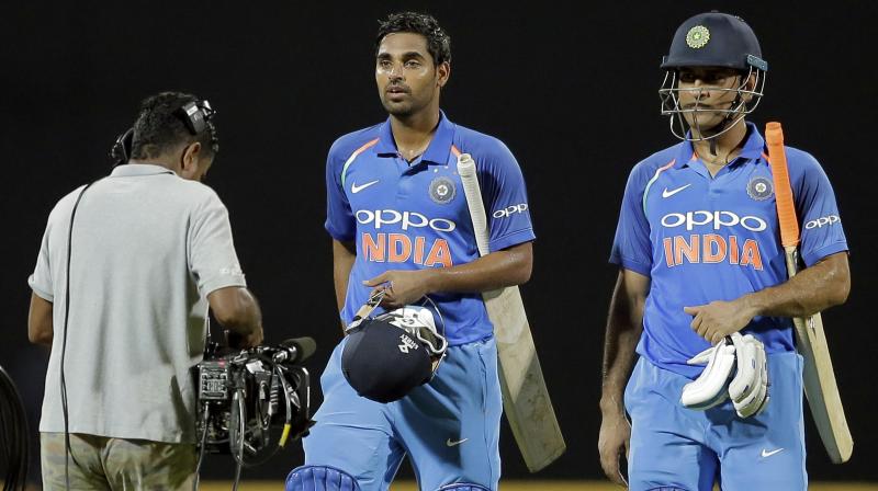 Bhuvneshwar Kumar and Mahendra SIngh Dhoni guided India to three-wicket win. (Photo: AP) Bhuvneshwar Kumar and Mahendra SIngh Dhoni guided India to three-wicket win. (Photo: AP)