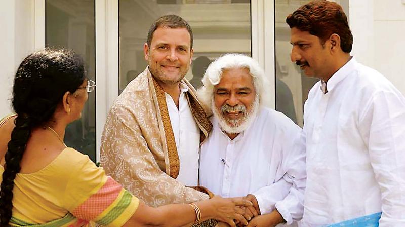 Congress chief Rahul Gandhi with revolutionary Telugu balladeer Gummadi Vittal Rao aka ‘Gaddar’, in New Delhi on Friday. (Photo: PTI) Congress chief Rahul Gandhi with revolutionary Telugu balladeer Gummadi Vittal Rao aka ‘Gaddar’, in New Delhi on Friday. (Photo: PTI)