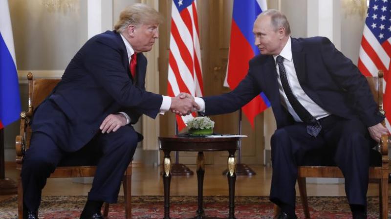 Trump reached out to shake Putin’s hand before the media were ushered out. (Photo: AP) Trump reached out to shake Putin’s hand before the media were ushered out. (Photo: AP)