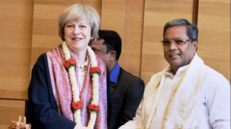 Karnataka Chief Minister Siddaramaiah welcomes U K Prime Minister Theresa May at a programme in Bengaluru on Tuesday (Photo: AP) Karnataka Chief Minister Siddaramaiah welcomes U K Prime Minister Theresa May at a programme in Bengaluru on Tuesday (Photo: AP)