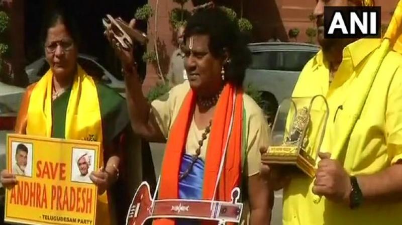 From dressing up as a cattle herder to a schoolboy, Chittoor MP has even donned a sari as part of the protest against denial of the status by the Centre. (Photo: ANI/Twitter) From dressing up as a cattle herder to a schoolboy, Chittoor MP has even donned a sari as part of the protest against denial of the status by the Centre. (Photo: ANI/Twitter)