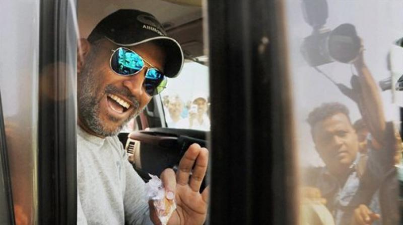 MS Dhoni waves at fans from his SUV after being spotted outside Ranchi's Birsa Munda airport. (Photo: PTI) MS Dhoni waves at fans from his SUV after being spotted outside Ranchi's Birsa Munda airport. (Photo: PTI)