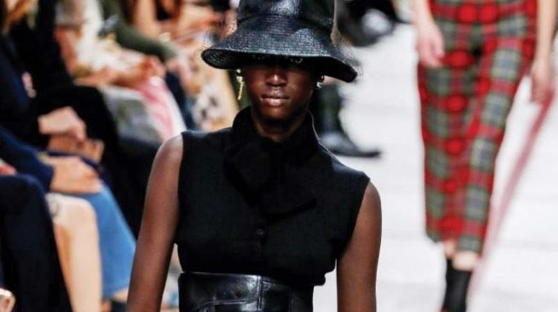 A model wearing a bucket hat and leather cumberband at the Dior’s tartan-heavy Paris autumn winter show. A model wearing a bucket hat and leather cumberband at the Dior’s tartan-heavy Paris autumn winter show.