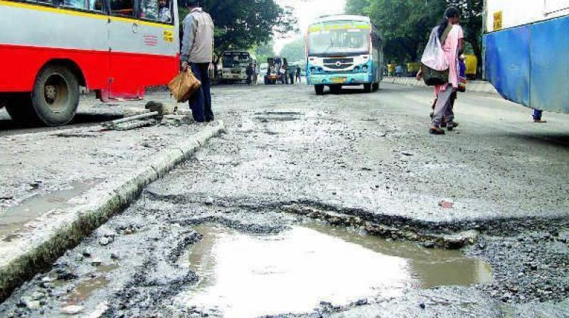 Motorists have to make their way on the uneven crater dotted and potholes filled road where driving is a back breaking exercise. Motorists have to make their way on the uneven crater dotted and potholes filled road where driving is a back breaking exercise.