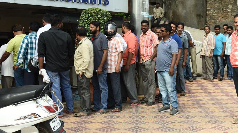 A 2017 file photo of people queuing up to buy liquor at a vend in Hyderabad. (DC Photo)