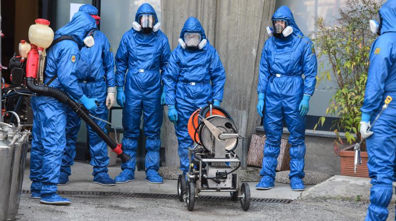 Russian Army specialists disinfect their gear outside the Honegger nursing home where 35 people have died so far from coronavirus in Albino, Italy, on Saturday. AFP Photo