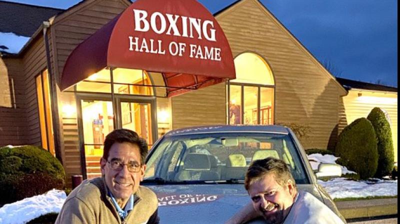 Boxing Hall of Fame Executive Director Ed Brophy (L) with a fan outside the HoF museum in Canastota, New York.