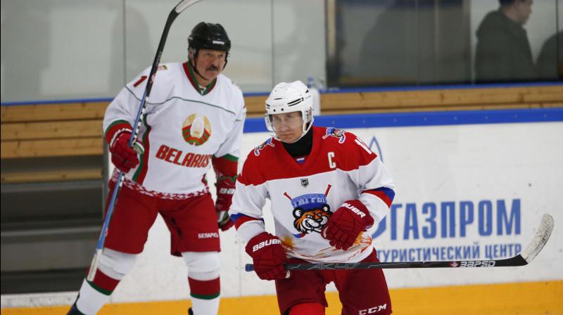 In this file photo, Belarusian President Alexander Lukashenko (L) and Russian President Vladimir Putin participate in a hockey match. AP Photo