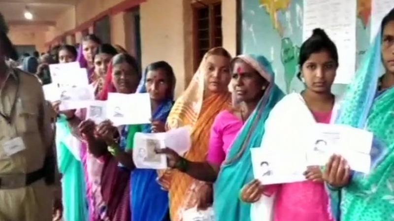 Women queue up outside booth no.50 in Hirepadasalgi village of Jamkhandi to cast their votes. (Photo: ANI/Twitter) Women queue up outside booth no.50 in Hirepadasalgi village of Jamkhandi to cast their votes. (Photo: ANI/Twitter)