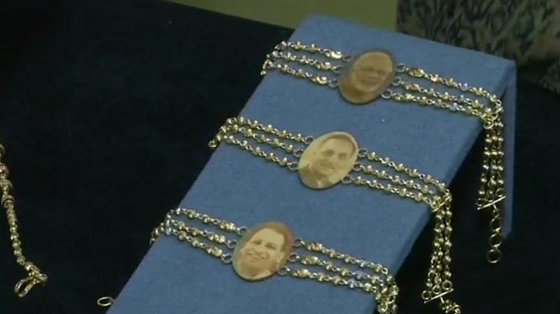 PM Modi, UP Chief Minister Yogi Adityanath and Gujarat Chief Minister Vijay Rupani on gold rakhis. (Photo: Twitter | ANI) PM Modi, UP Chief Minister Yogi Adityanath and Gujarat Chief Minister Vijay Rupani on gold rakhis. (Photo: Twitter | ANI)