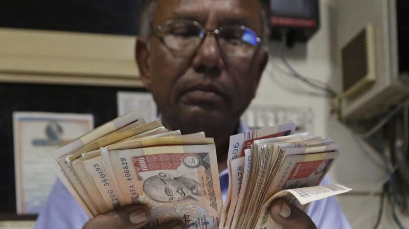 A man counts Rs 1000 currency notes at a fuel pump in Ahmadabad. (Photo: AP) A man counts Rs 1000 currency notes at a fuel pump in Ahmadabad. (Photo: AP)