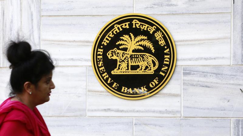 A woman walks past a logo of the Reserve Bank of India in front of it's headquarters in Mumbai. (Photo: AP) A woman walks past a logo of the Reserve Bank of India in front of it's headquarters in Mumbai. (Photo: AP)