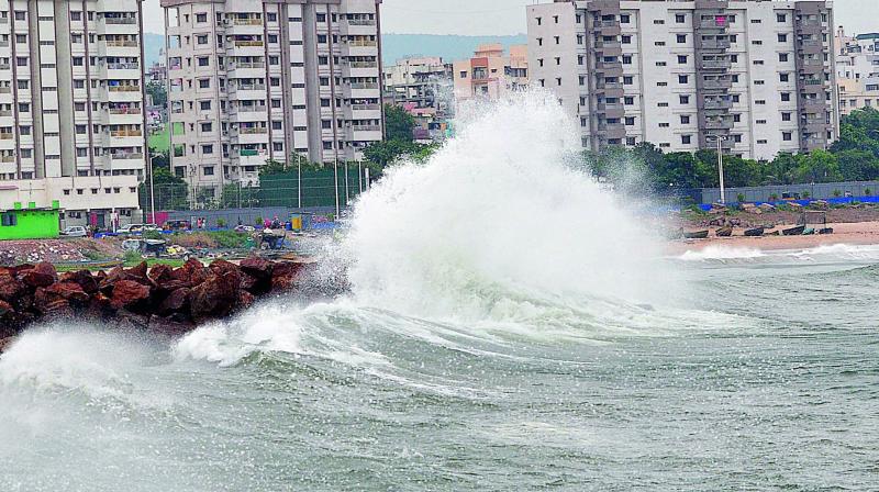Massive waves are seen during a high tide caused by the approaching cyclone Titli, in Visakhapatnam on Wednesday. Image: P Narasimha Murthy Massive waves are seen during a high tide caused by the approaching cyclone Titli, in Visakhapatnam on Wednesday. Image: P Narasimha Murthy