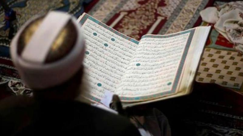 A person reading the Holy Quran A person reading the Holy Quran