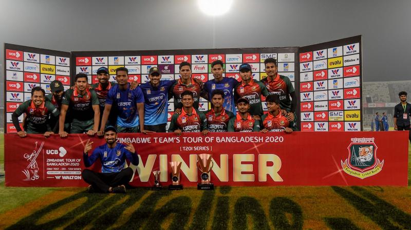 Bangladesh players pose with the trophy after winning the Twenty20 international series against Zimbabwe 2-0 at the Sher-e-Bangla National Cricket Stadium in Dhaka on March Wednesday. AFP Photo