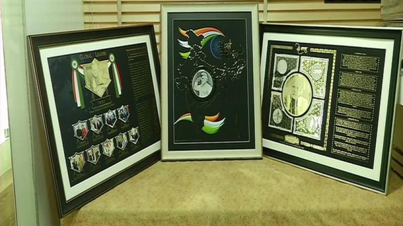 A jeweller in Rajkot has made three unique mementos from precious metals for Prime Minister Narendra Modi for sweeping recently concluded Lok Sabha elections. (Photo: ANI) A jeweller in Rajkot has made three unique mementos from precious metals for Prime Minister Narendra Modi for sweeping recently concluded Lok Sabha elections. (Photo: ANI)