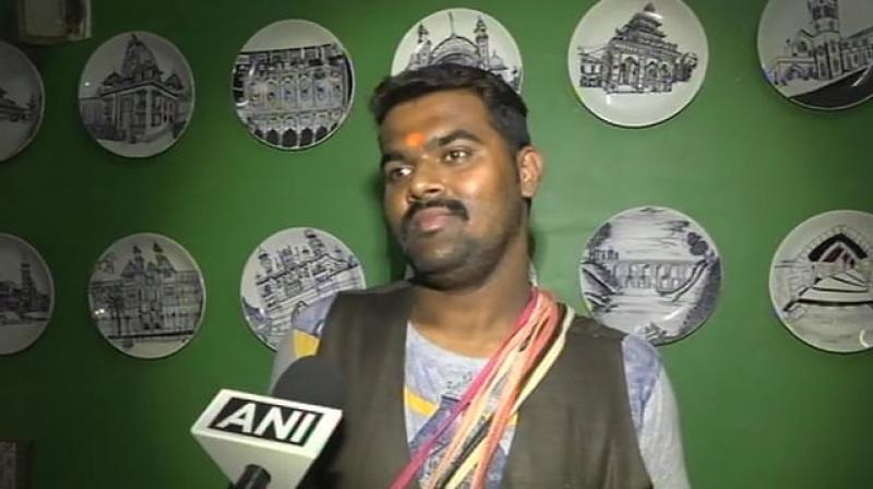 A hawker, who used to mimick politicians while selling toys on trains, was arrested at Surat Railway station on Friday by the Railway Protection Force (RPF). (Photo: Twitter/ ANI) A hawker, who used to mimick politicians while selling toys on trains, was arrested at Surat Railway station on Friday by the Railway Protection Force (RPF). (Photo: Twitter/ ANI)