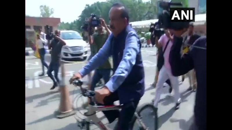 The Minister of Health and Family Welfare was photographed while riding to office, dressed in formals. (Photo: ANI) The Minister of Health and Family Welfare was photographed while riding to office, dressed in formals. (Photo: ANI)