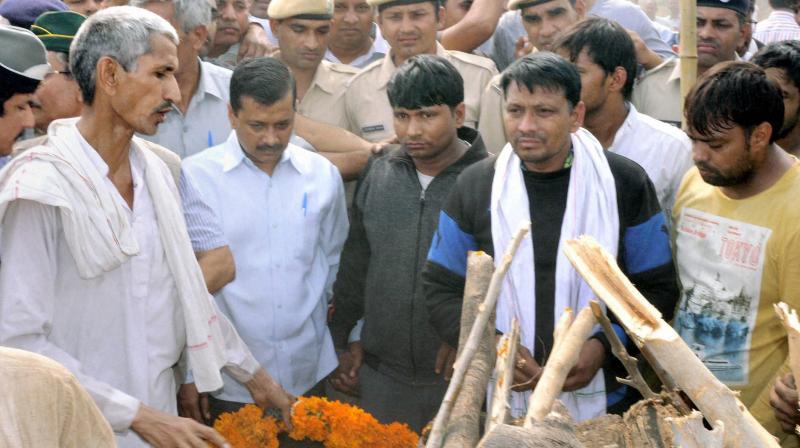 Delhi CM Arvind Kejriwal attends the cremation ceremony of ex-serviceman Ram Kishan Grewal at his village Bamla in Bhiwani, Haryana. (Photo: PTI) Delhi CM Arvind Kejriwal attends the cremation ceremony of ex-serviceman Ram Kishan Grewal at his village Bamla in Bhiwani, Haryana. (Photo: PTI)