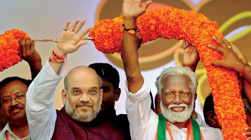 BJP president Amit Shah and party’s Kerala unit chief Kummanam Rajasekharan wave to the crowd at a rally in Thiruvananthapuram. (Photo: PTI) BJP president Amit Shah and party’s Kerala unit chief Kummanam Rajasekharan wave to the crowd at a rally in Thiruvananthapuram. (Photo: PTI)