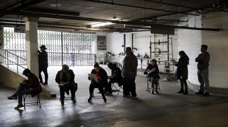 People waiting to file for unemployment benefits. (Photo- AP)