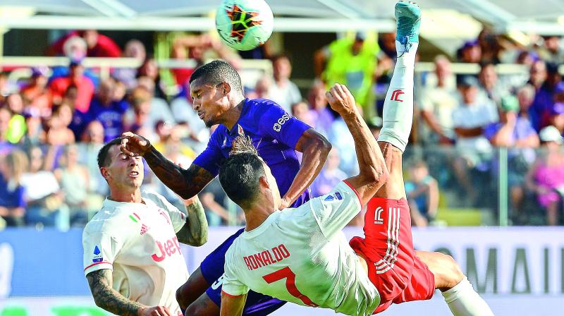 Portuguese forward Cristiano Ronaldo performs an overhead kick despite Fiorentina’s Brazilian defender Dalbert during the Italian Serie A football match on Saturday. (Photo: AFP) Portuguese forward Cristiano Ronaldo performs an overhead kick despite Fiorentina’s Brazilian defender Dalbert during the Italian Serie A football match on Saturday. (Photo: AFP)