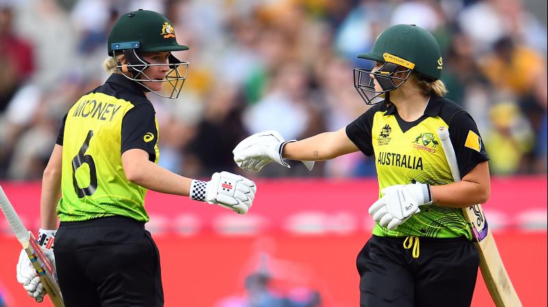 Australia's Alyssa Healy and Beth Mooney bumb gloves during the Twenty20 womens World Cup cricket final match between Australia and India in Melbourne on March 8, 2020 Australia's Alyssa Healy and Beth Mooney bumb gloves during the Twenty20 womens World Cup cricket final match between Australia and India in Melbourne on March 8, 2020