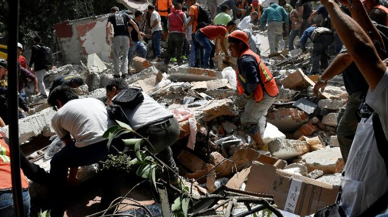 People remove debris of a building which collapsed after a quake rattled Mexico City (Photo: AFP) People remove debris of a building which collapsed after a quake rattled Mexico City (Photo: AFP)