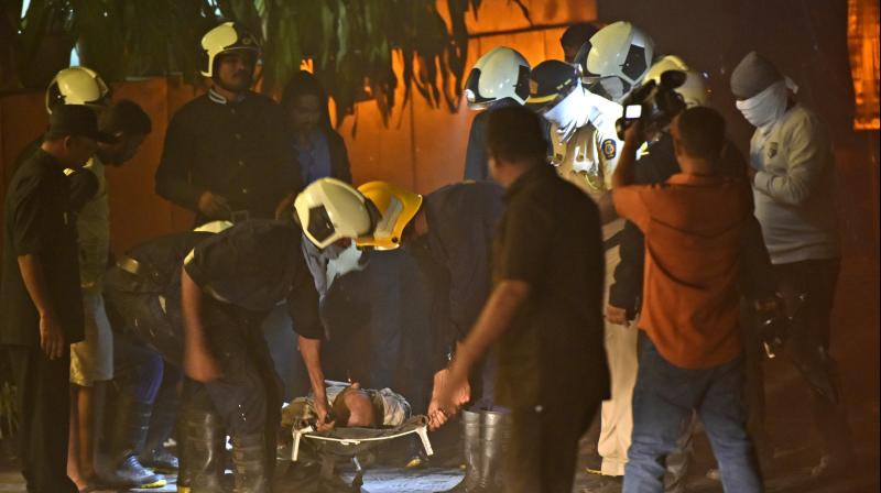 Fire officials carry an injured person in a fire at a restaurant in Kamala Mills Compund. (Photo: AP) Fire officials carry an injured person in a fire at a restaurant in Kamala Mills Compund. (Photo: AP)