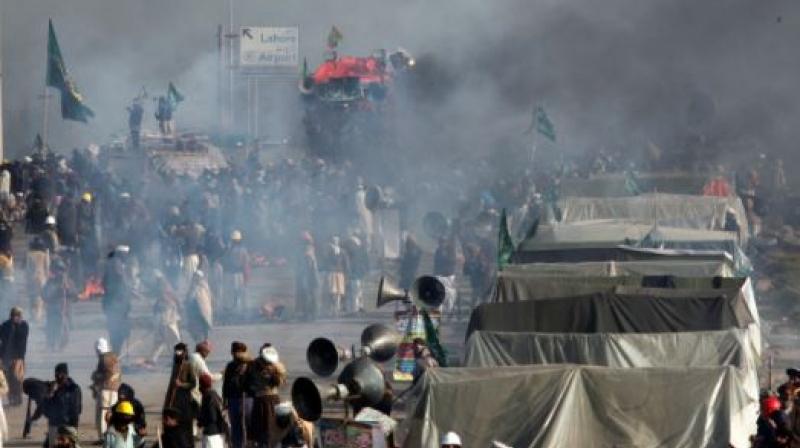Demonstrators protest as police fire tear gas shells to disperse them during a clash in Islamabad, Pakistan. (Photo: AP) Demonstrators protest as police fire tear gas shells to disperse them during a clash in Islamabad, Pakistan. (Photo: AP)