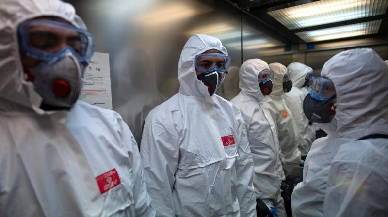 Members of the Military Emergencies Unit (UME) use a lift as they carry out a general disinfection at the Sant Antoni extended care facility in Barcelona. AFP Photo