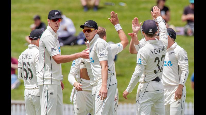 New Zealands players celebrate their victory against West Indies in the first Test cricket match at Seddon Park in Hamilton on Sunday. AFP