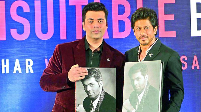 In writing: Karan Johar and Shah Rukh Khan launching the book. (Photos: Viral Bhayani) In writing: Karan Johar and Shah Rukh Khan launching the book. (Photos: Viral Bhayani)
