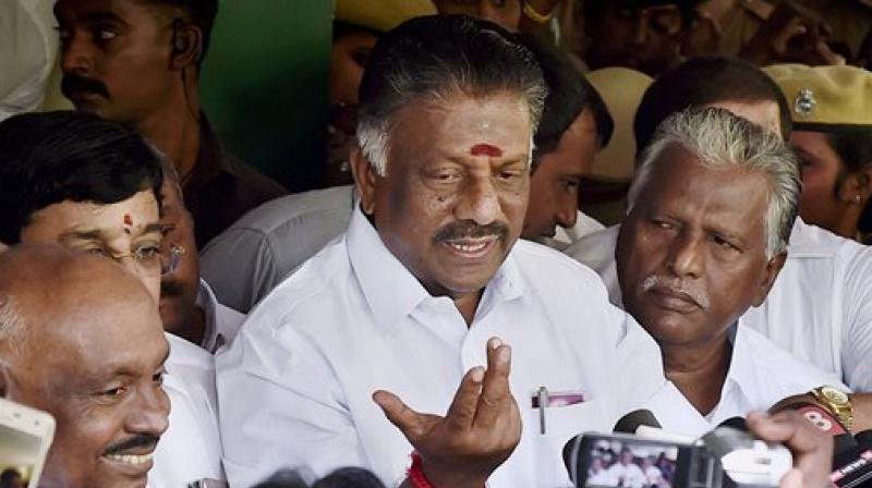 Tamil Nadu Chief Minister O Panneerselvam, flamke by supporters, addresses a press conference at his residence in Chennai on Wednesday. (Photo: PTI) Tamil Nadu Chief Minister O Panneerselvam, flamke by supporters, addresses a press conference at his residence in Chennai on Wednesday. (Photo: PTI)
