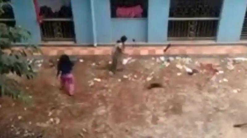 A video grab shows two women clobbering 16 puppies to death in Kolkata. (Photo: Sourced from Facebook) A video grab shows two women clobbering 16 puppies to death in Kolkata. (Photo: Sourced from Facebook)