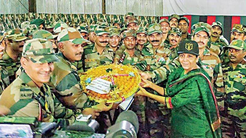 Defence Minister Nirmala Sitharaman celebrating Diwali with soldiers, their families at Hyulong in Arunachal Pradesh on Wednesday. (PTI) Defence Minister Nirmala Sitharaman celebrating Diwali with soldiers, their families at Hyulong in Arunachal Pradesh on Wednesday. (PTI)