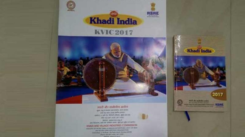 PM Narendra Modi spinning the charkha on the 2017 KVIC calendar. (Photo: Twitter) PM Narendra Modi spinning the charkha on the 2017 KVIC calendar. (Photo: Twitter)