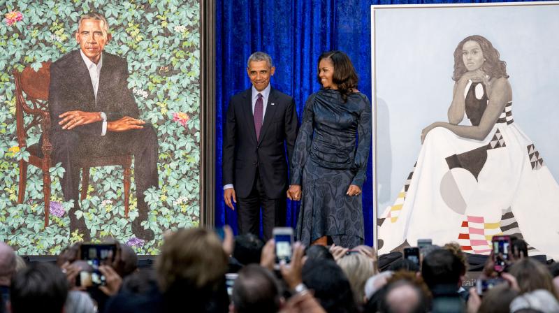 Former President Barack Obama and former first lady Michelle Obama stand on stage as their official portraits are unveiled at a ceremony at the Smithsonian's National Portrait Gallery, Monday, Feb. 12, 2018, in Washington. (Photo: AP) Former President Barack Obama and former first lady Michelle Obama stand on stage as their official portraits are unveiled at a ceremony at the Smithsonian's National Portrait Gallery, Monday, Feb. 12, 2018, in Washington. (Photo: AP)
