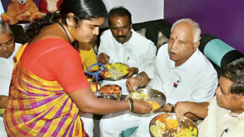 BJP Karnataka chief B.S. Yeddyurappa, along with party leaders, having a breakfast at the house of a Dalit at Kakri Basaveshwar Nagar in Hubballi. BJP Karnataka chief B.S. Yeddyurappa, along with party leaders, having a breakfast at the house of a Dalit at Kakri Basaveshwar Nagar in Hubballi.