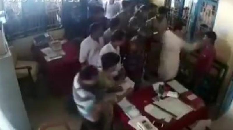 A video showing Debburman assaulting Mintu Debbarma inside a police station in Khowai district, around 50km from here, has gone viral on social media. (Image: ANI twitter) A video showing Debburman assaulting Mintu Debbarma inside a police station in Khowai district, around 50km from here, has gone viral on social media. (Image: ANI twitter)