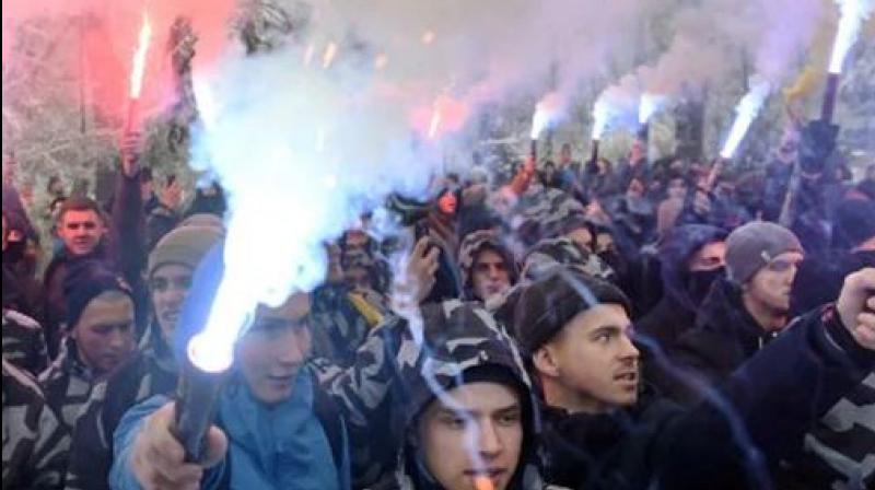 Activists hold flares during their rally in front of the Ukrainian parliament. (Photo: AFP) Activists hold flares during their rally in front of the Ukrainian parliament. (Photo: AFP)